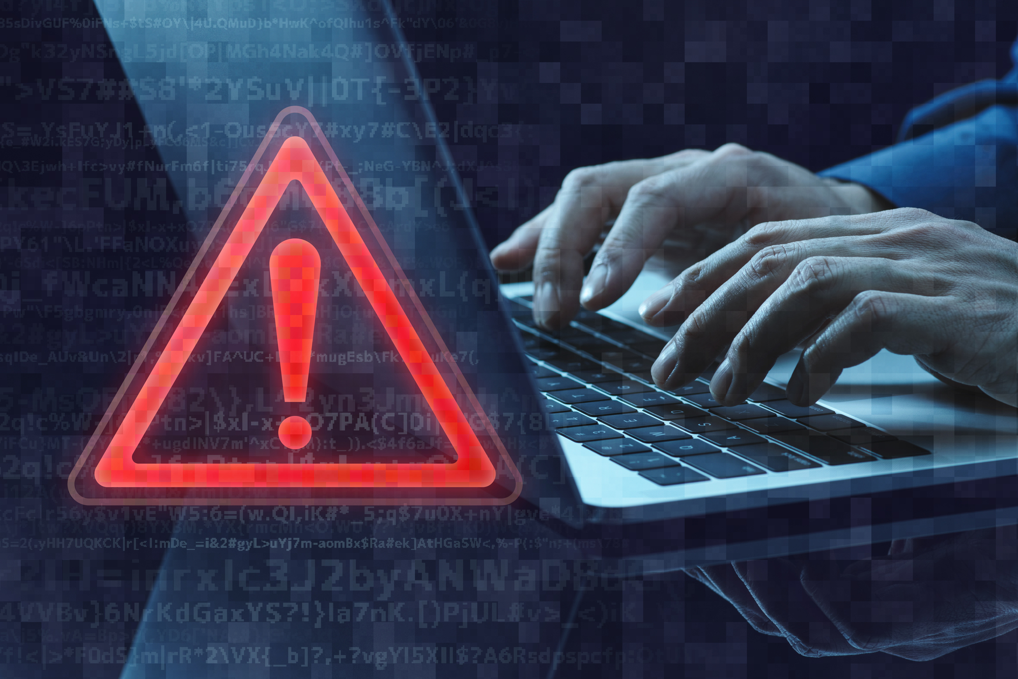 パソコン操作中に警告マークが表示されているサイバーセキュリティのイメージ